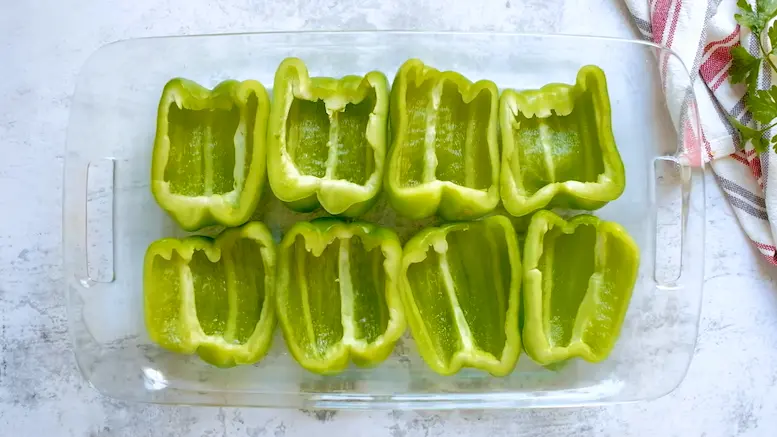 Prepare green bell peppers for stuffing