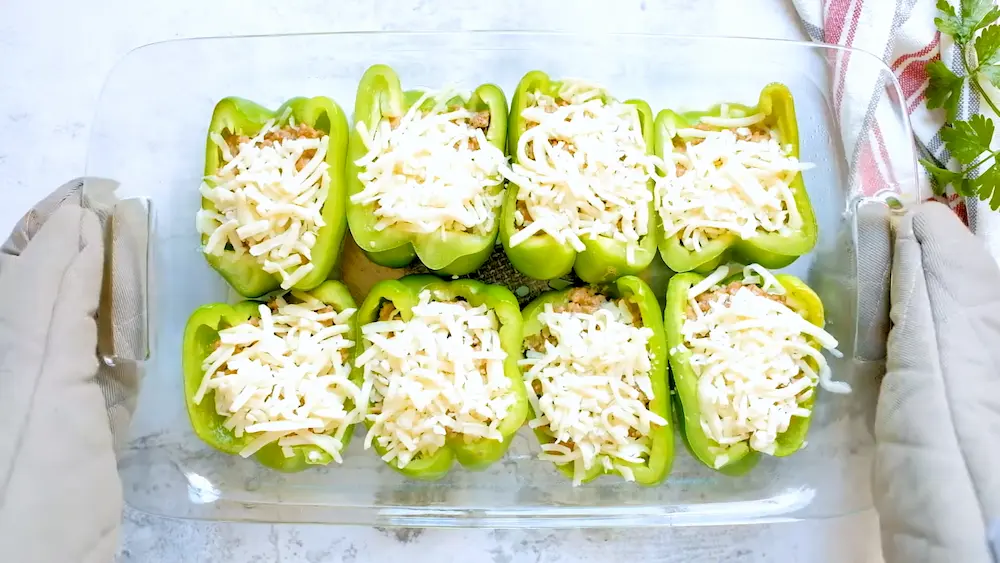 adding cheese to the Ground Beef Stuffed Peppers