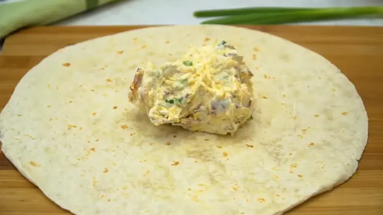 spread the cheese and mixture over tortilla for Turkey Pinwheels -1